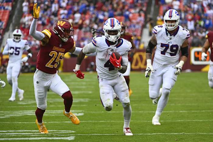 Sep 24, 2023; Landover, Maryland, USA; Buffalo Bills running back James Cook (4) runs past Washington Commanders cornerback Benjamin St-Juste (25) during the second half at FedExField.